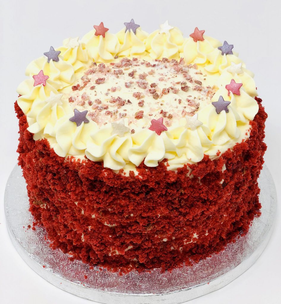 Bright red luxury handmade red velvet birthday cake with sprinkles