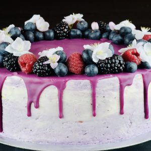 Delicious handmade Lemon and Blueberry celebration cake with fruit and drip topping