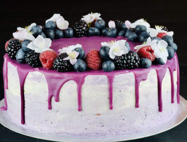 Delicious handmade Lemon and Blueberry celebration cake with fruit and drip topping