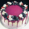 Top of Lemon and Blueberry celebration cake with fruit and flower decoration.