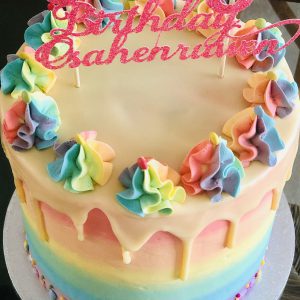 luxury gourmet colourful rainbow birthday cake with icing