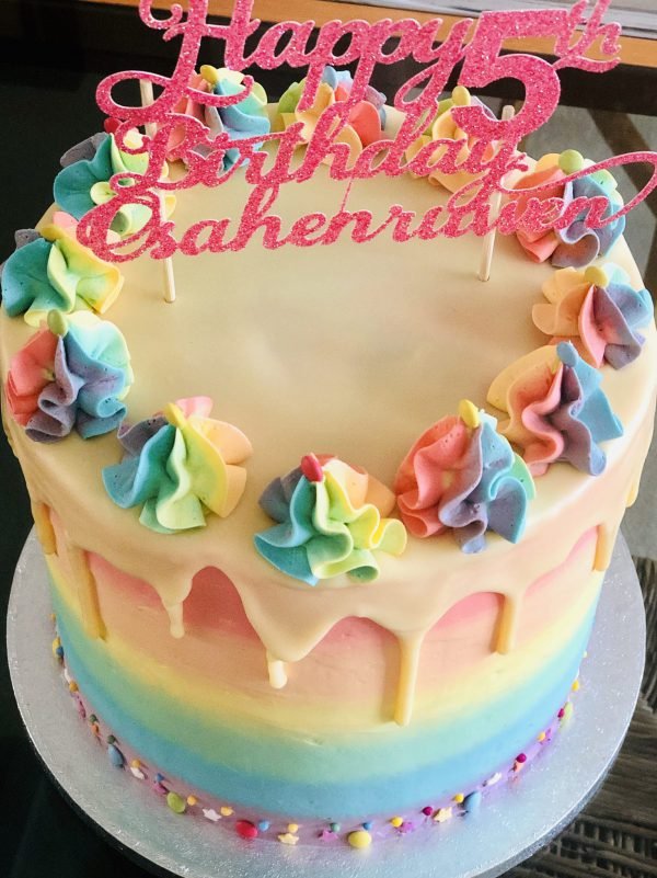 luxury gourmet colourful rainbow birthday cake with icing