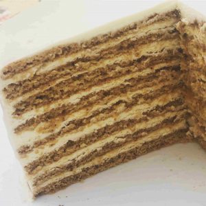 slice of luxury golden honey cake with cream cheese filling