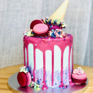 Unique handcrafted luxury pink celebration cake with ice cream topping