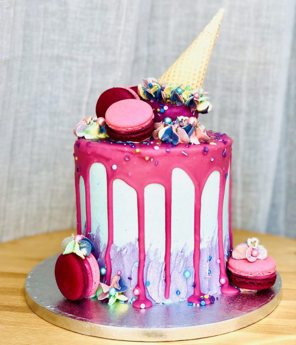 Unique handcrafted luxury pink celebration cake with ice cream topping