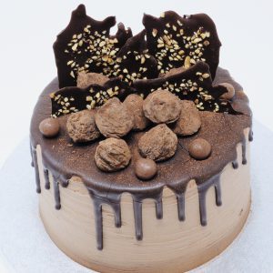 Egg-free gourmet handmade chocolate celebration cake with ganache drip