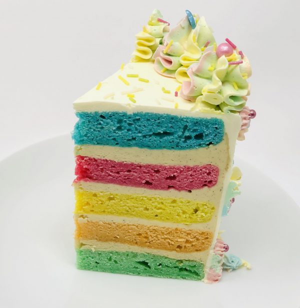 artisan handcrafted slice of rainbow birthday celebration cake