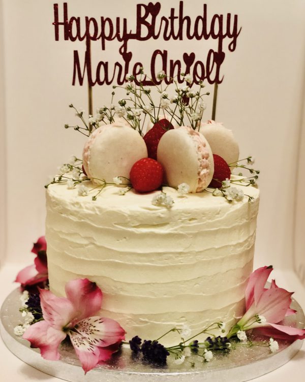 Handmade french macaron and strawberry celebration cake