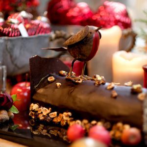 Gourmet Christmas chocolate yule log with robin topping