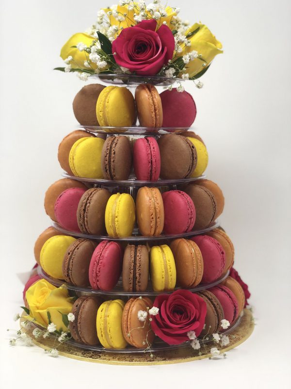 Colourful freshly baked 5-tier tower of French macarons