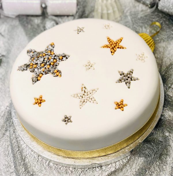 Gourmet traditional Christmas cake with snowflake and stars
