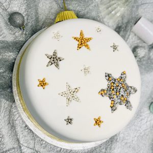 Decorative Christmas topping on traditional fruit cake with icing