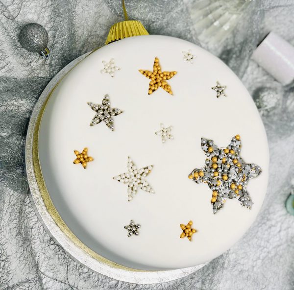 Decorative Christmas topping on traditional fruit cake with icing