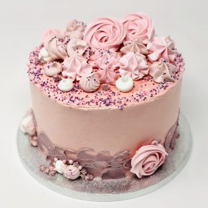 Handcrafted baby pink swirl cake with freshly baked meringue kisses