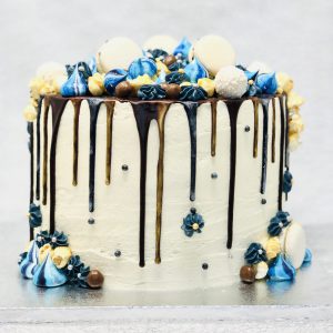 Blue and gold ganache drip detail on gourmet celebration cake