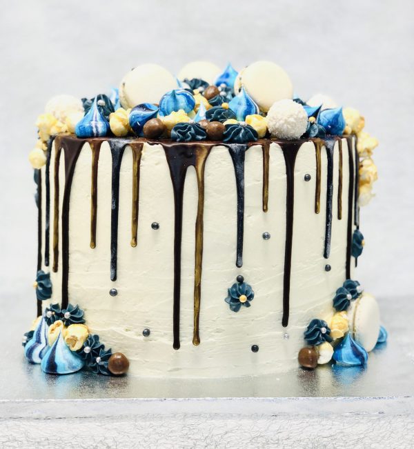 Blue and gold ganache drip detail on gourmet celebration cake