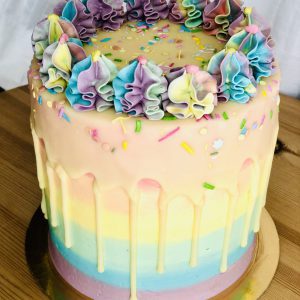 Unique vibrantly colourful birthday pinata cake with handmade icing