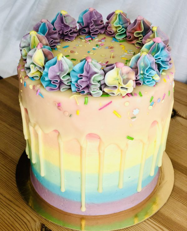 Unique vibrantly colourful birthday pinata cake with handmade icing