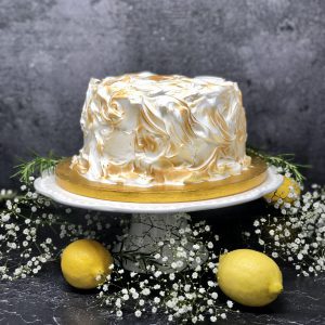 Luxurious lemon meringue cake covered in Italian meringue