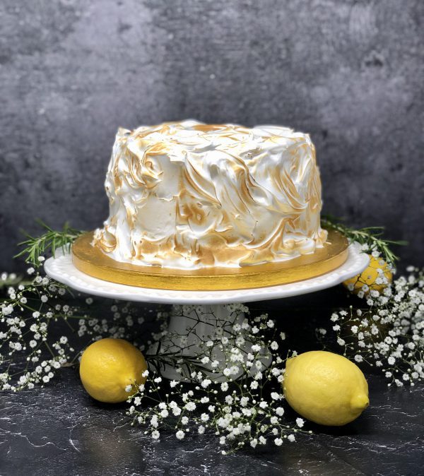 Luxurious lemon meringue cake covered in Italian meringue