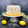 Luxurious lemon meringue cake covered in Italian meringue