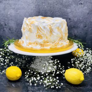 Luxurious lemon meringue cake covered in Italian meringue