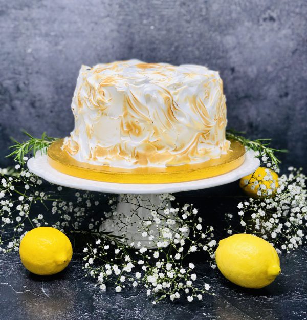 Luxurious lemon meringue cake covered in Italian meringue