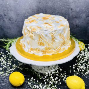 Luxurious lemon meringue cake covered in Italian meringue