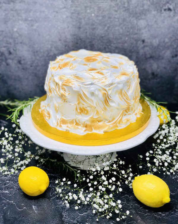 Luxurious lemon meringue cake covered in Italian meringue